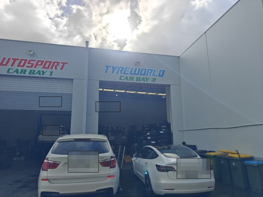 Autosport Tyre World workshop photo with number plate redacted