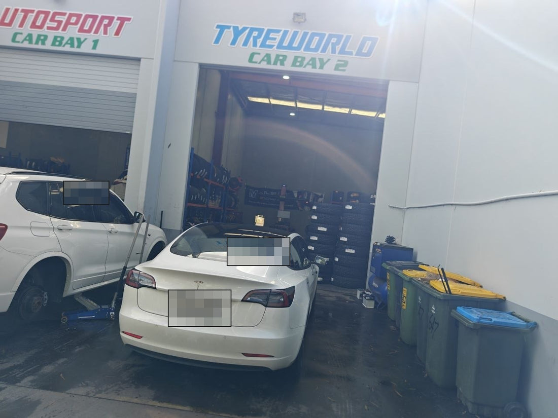 Autosport Tyre World workshop photo with number plate redacted