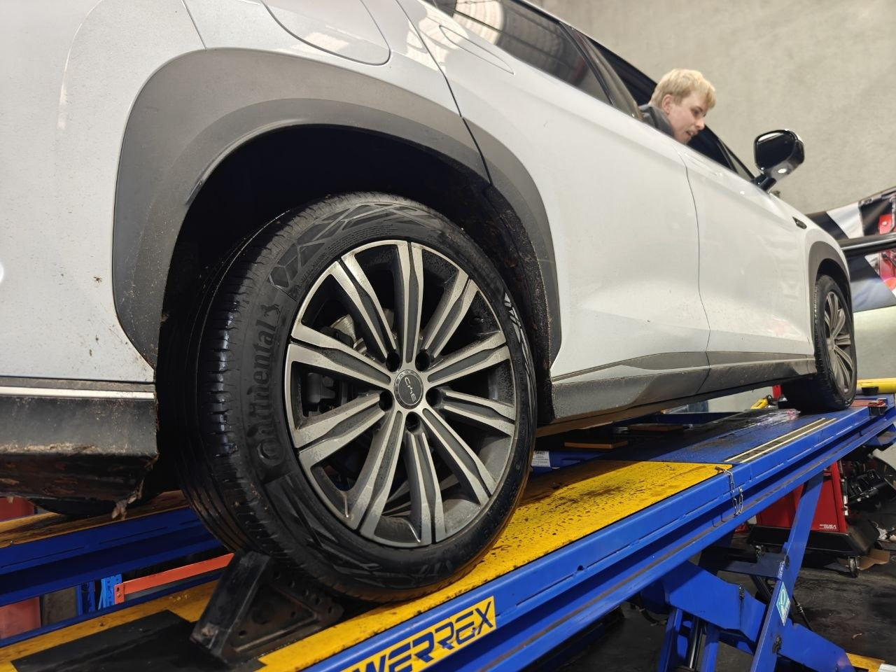 Autosport Tyre World workshop photo with number plate redacted