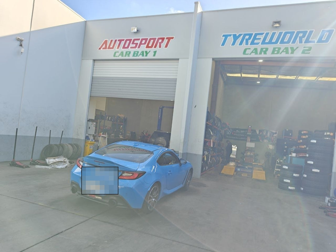 Autosport Tyre World workshop photo with number plate redacted